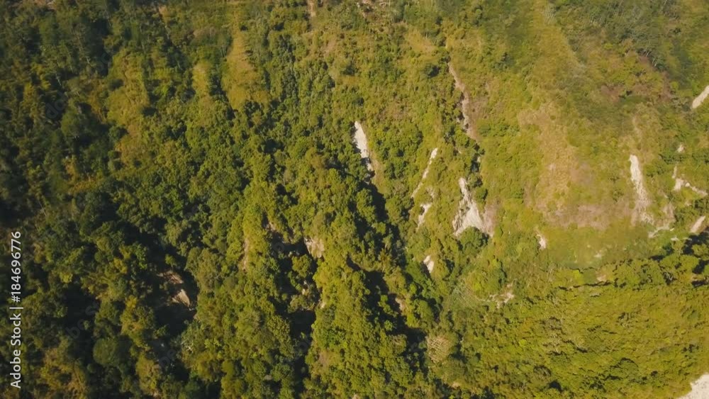 Aerial view of Slopes of the mountains are covered tropical forest. Landscape, mountains, rainforest, trees. Bali,Indonesia. 4K video. Travel concept. Aerial footage. Aerial view of Slopes of the mountains are covered tropical forest. Landscape, mountains, rainforest, trees. Bali,Indonesia. 4K video. Travel concept. Aerial footage.