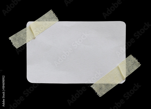 ripped note paper with adhesive tape on a black background