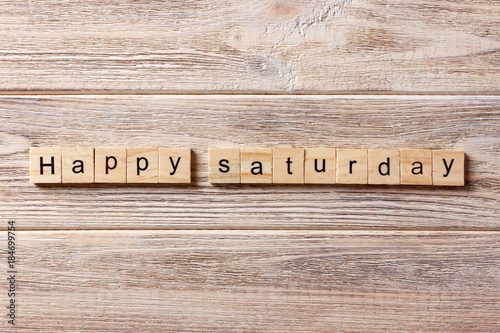 Happy Saturday word written on wood block. Happy Saturday text on table, concept