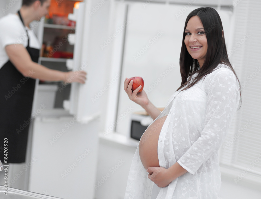 Happy pregnant couple of vegetarians in the kitchen. Happy pregnant couple of vegetarians in the kitchen.