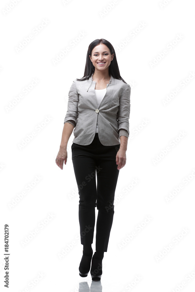 In full growth. The modern young woman confidently goes forward. In full growth. The modern young woman confidently goes forward.