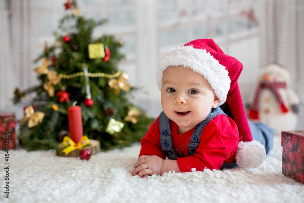 Portrait of newborn baby in Santa clothes and christmas hat Portrait of newborn baby in Santa clothes and christmas hat