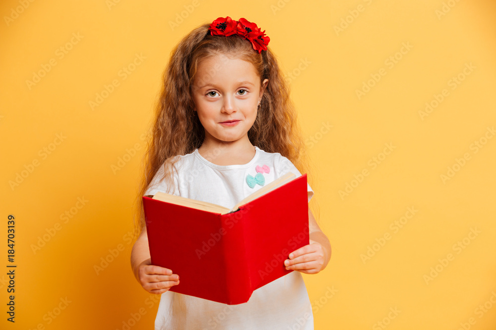 Little pretty girl reading book looking camera. Little pretty girl reading book looking camera.