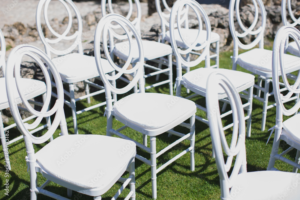 White chair decorating for wedding ceremony