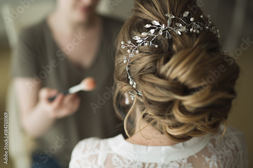 Stylist makes hair the bride