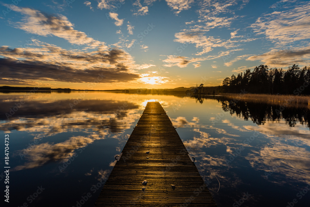 Sunset over a lake in Nykroppa, Filipstad, Sweden with a jetty