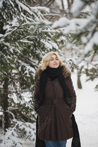 Beautiful woman posing in a winter forest. © Artem Zakharov