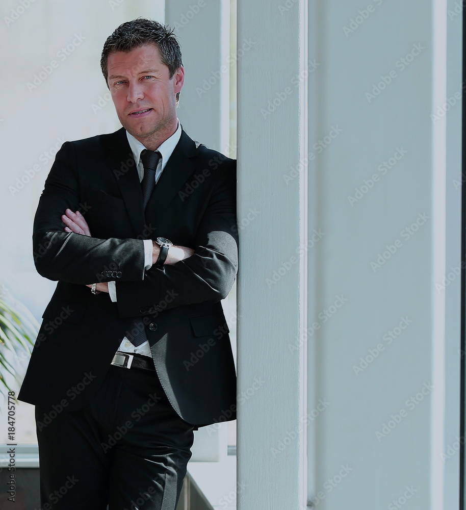 Full length of a business man with crossed arms in the modern of