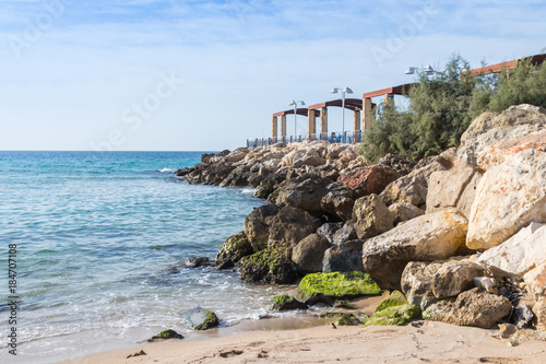 Breakwater  overlooking the sea with a promenade terrace on the waterfront of Nahariya city in Israel photo