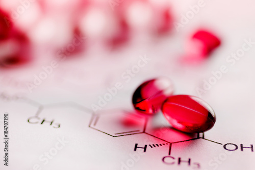 Painkiller tablets - pink caps with molecules chemical formulas - healthcare and medicine photo