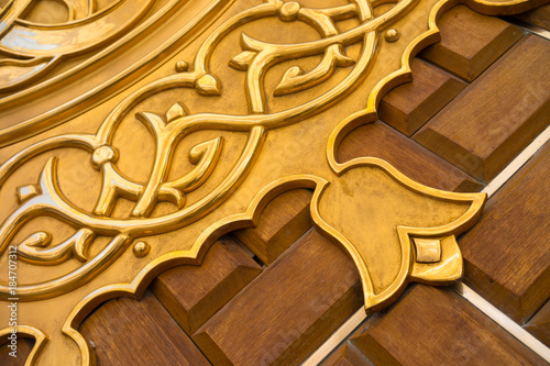 MEDINA, SAUDI ARABIA - 16TH NOV 2017; Close-up view of golden door for Mosque Al-Nabawi in Medina, Saudi Arabia. It is the second-holiest site in Islam and the mosque was built by Prophet Muhammad in 