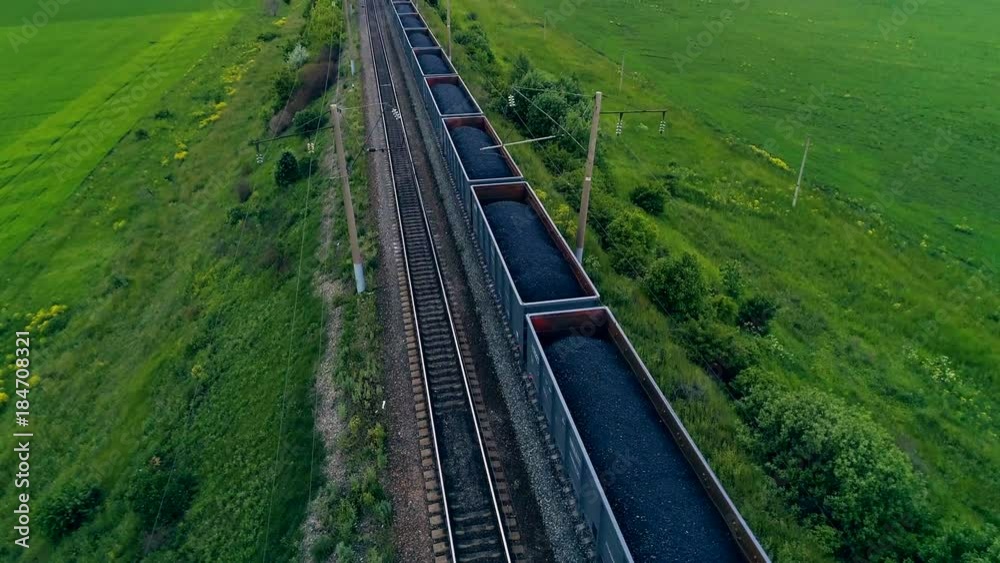 Big cargo train transporting coal. Aerial shot. Close-up.
