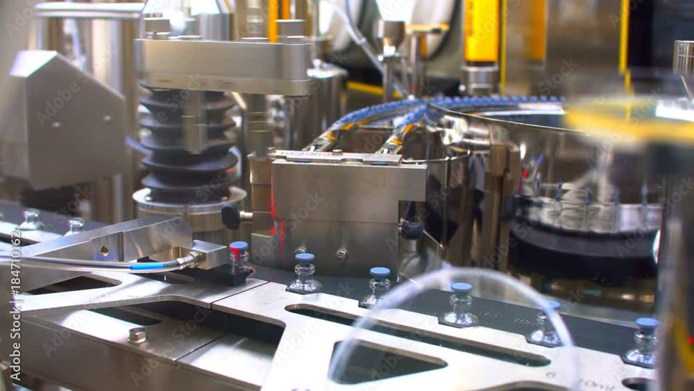 Pharmaceutical manufacturing line at factory. Pharmaceutical quality control. Pharmaceutical manufacturing line at factory. Pharmaceutical quality control.