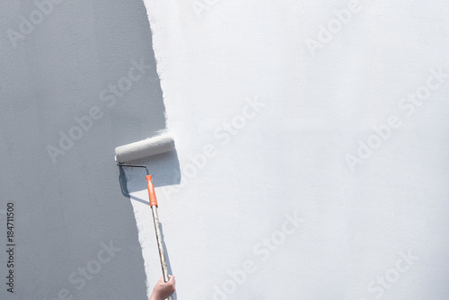 Roller Brush Painting, Worker painting on steel surface wall by the roller brush for protection and corrosion.