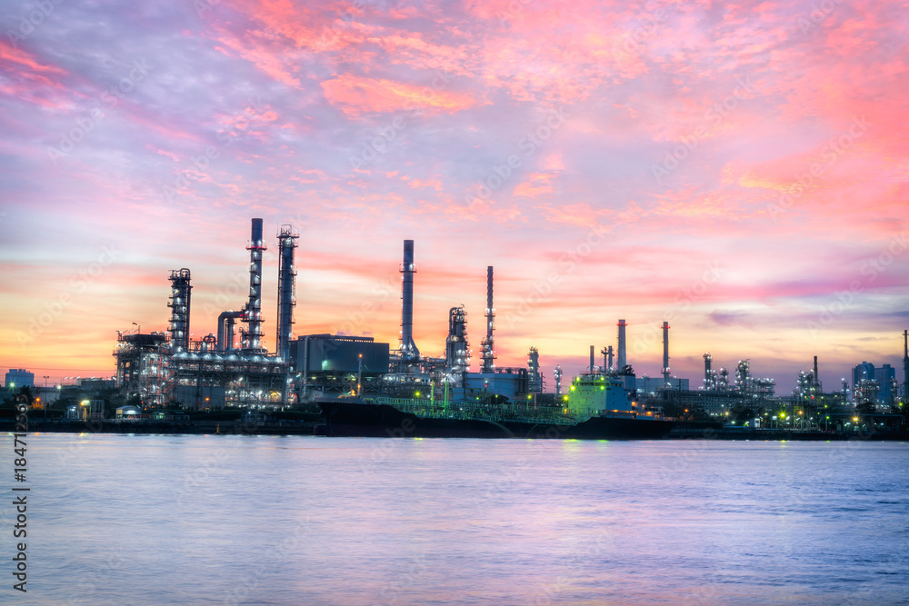 Oil Refinery Industry Plant at dramatic colorful sunrise dawn sky background.