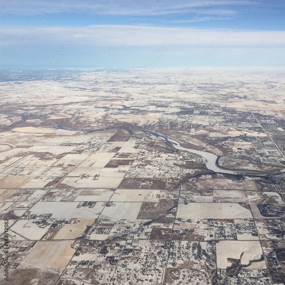 Aerial view of prairie fields in winter.