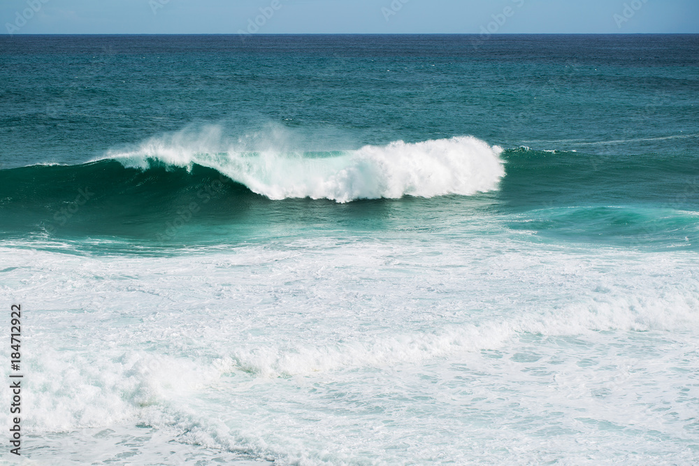 Fototapeta premium view from the beach to a tropical island and some granite rocks in the sea