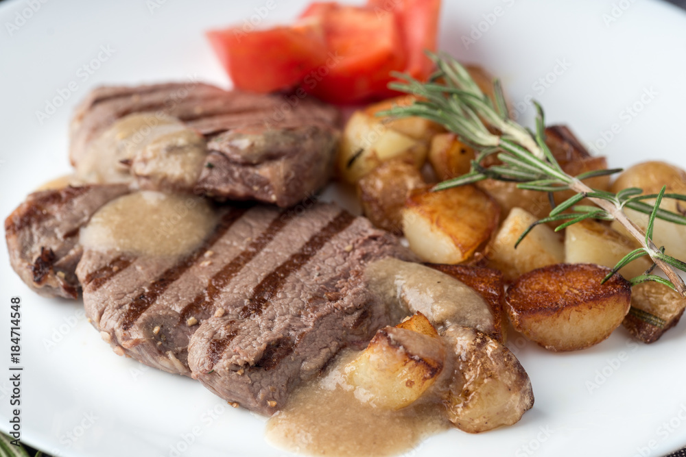Gourmet grilled steak with rosemary and fried potato