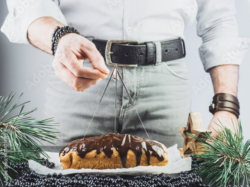 Young guy fomenting Bengal lights on a background of a Christmas biscuit cake photo