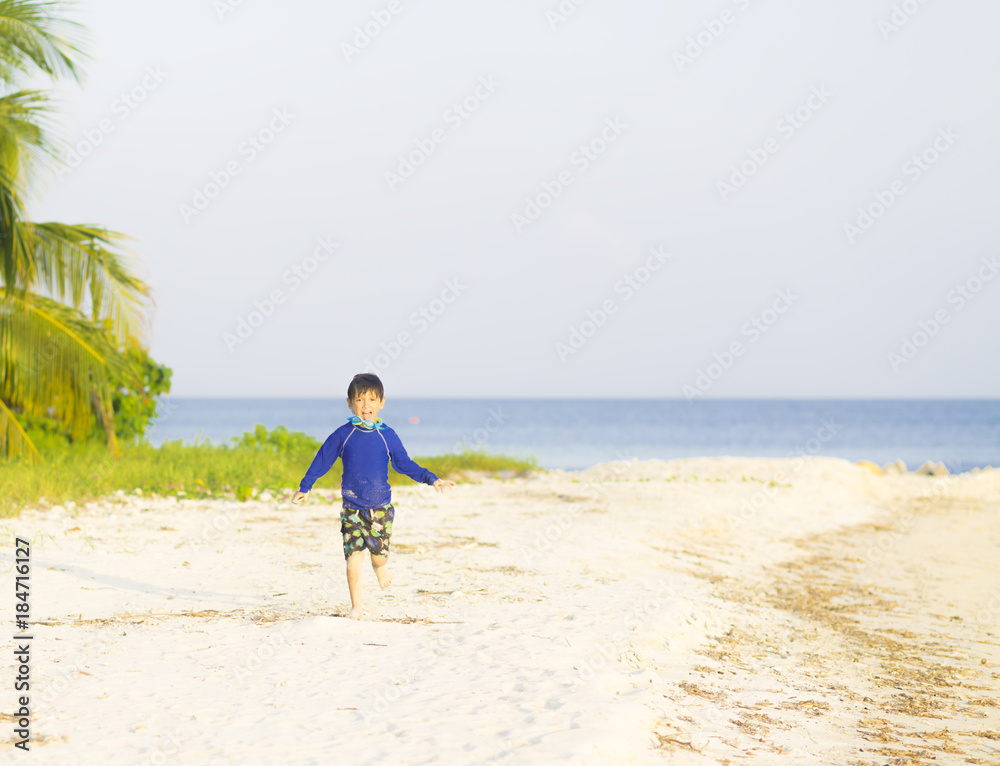Happy boy running on the beach Happy boy running on the beach