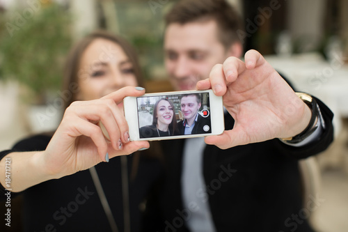Beautiful couple taking selfie photo in a restaurant