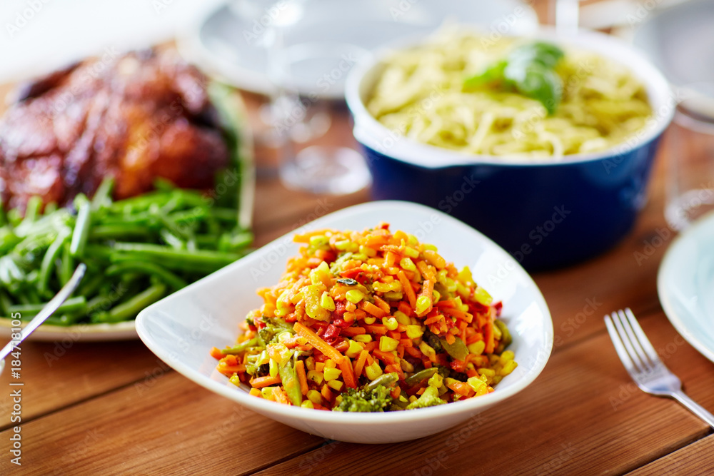 vegetable salad with corn and other food on table vegetable salad with corn and other food on table