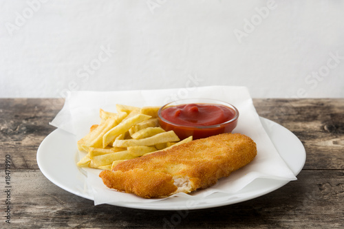 Traditional British fish and chips on wooden table. Copyspace