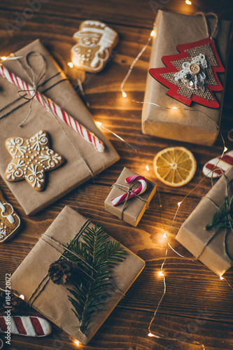 Wrapped vintage Christmas presents on wooden background, view from above 