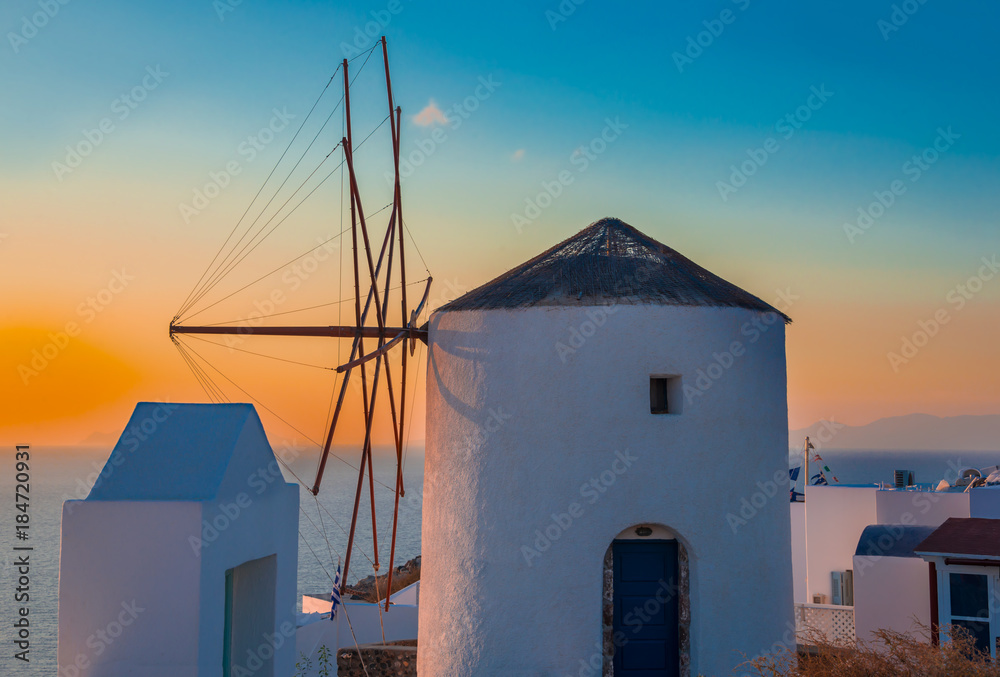 Windmill on sunset on Santorini Island in Greece 