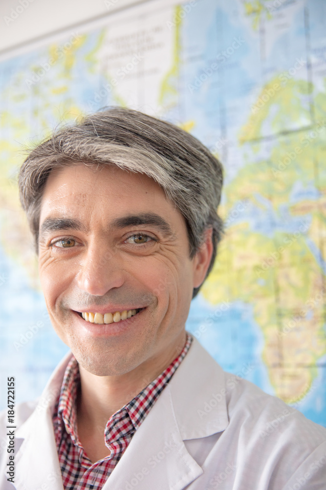 Confident school teacher happy smiling in the classroom Confident school teacher happy smiling in the classroom