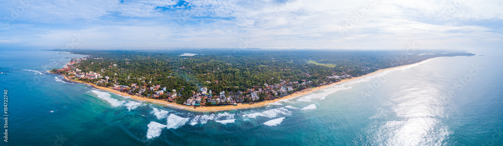 Aerial view of the town of Hikkaduwa with its beaches, surfspots and buildings. Sri Lanka
