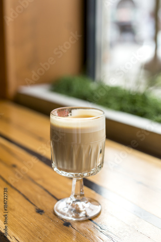Latte in a stylish glass. Coffee drink