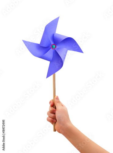 Kid hand holding a blue pinwheel close up isolated on white background.