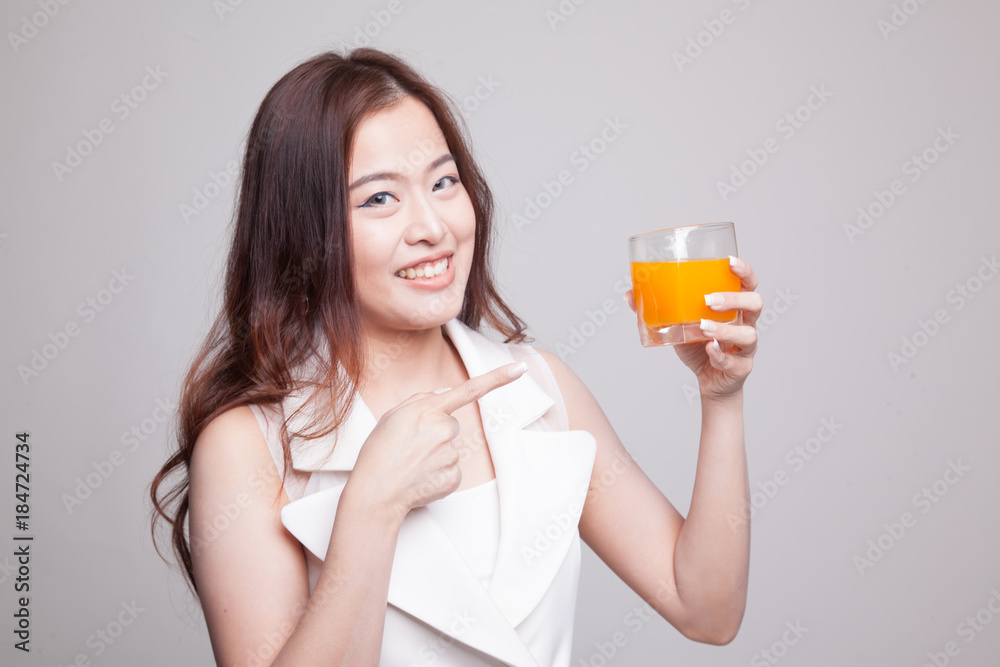 Young Asian woman point to orange juice. Young Asian woman point to orange juice.