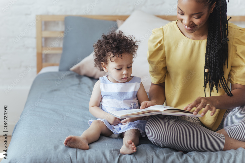 Obraz premium Mother and Child Reading a Book