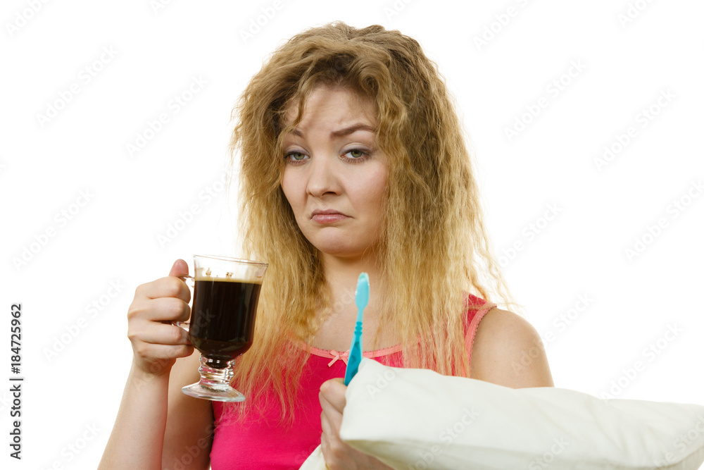 Tired woman holding toothbrush and coffee Tired woman holding toothbrush and coffee