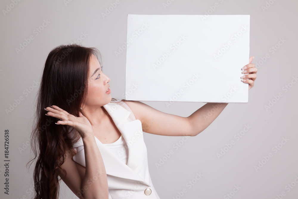 Young Asian woman surprise with white blank sign. Young Asian woman surprise with white blank sign.