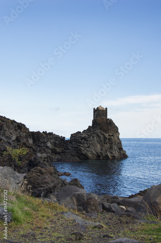 ancient watchtower in lava stone in Sicily