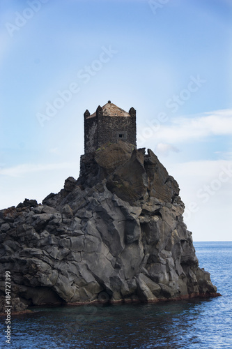 ancient watchtower in lava stone in Sicily