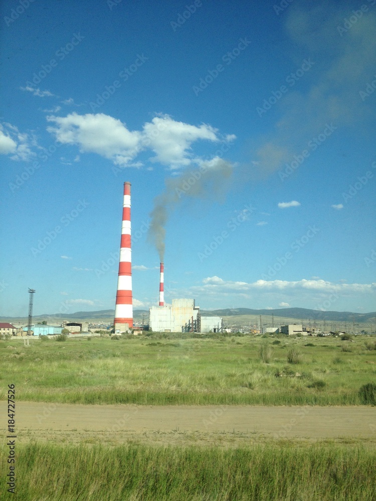 Thermal power plant in the green field on sunny day