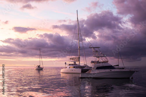 Yacht - Catamaran in the tropical sea at sunset. Yachting / Luxury Sailing theme. © Artem Zakharov