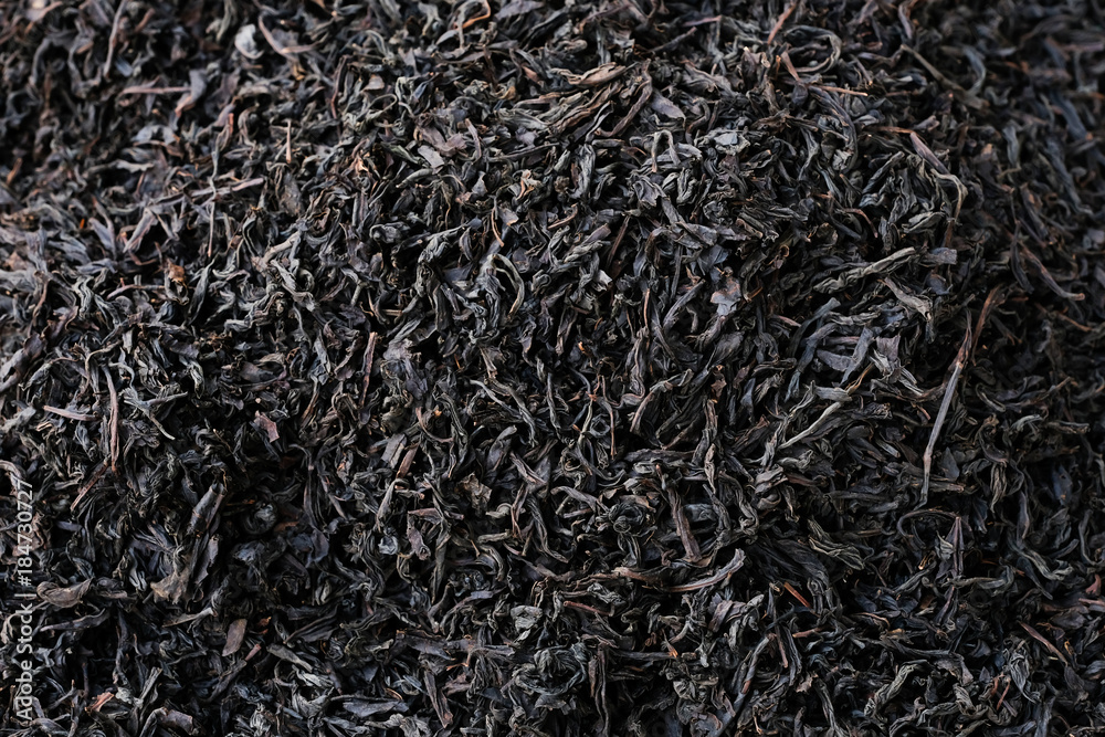 Dried tea leaves close-up texture background. Dry black tea leaves. Dried tea leaves close-up texture background. Dry black tea leaves.