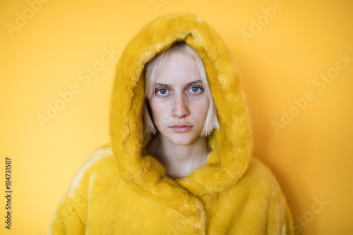 Portrait of woman in plush yellow coat