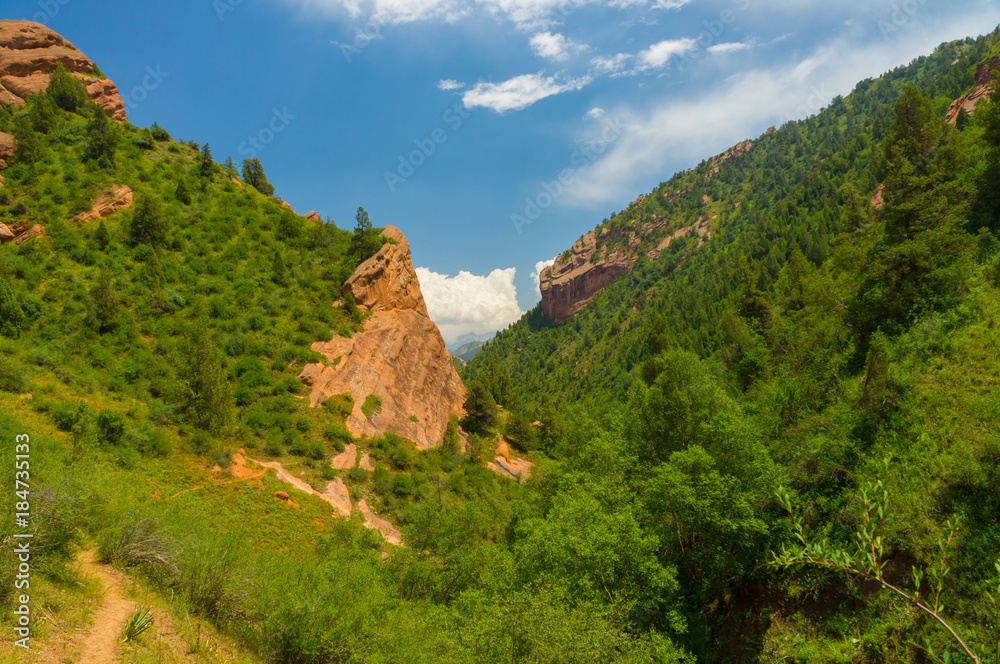 Fantastic mountain landscape, rocks, blue sky and green vegetation in Kozhokelen
