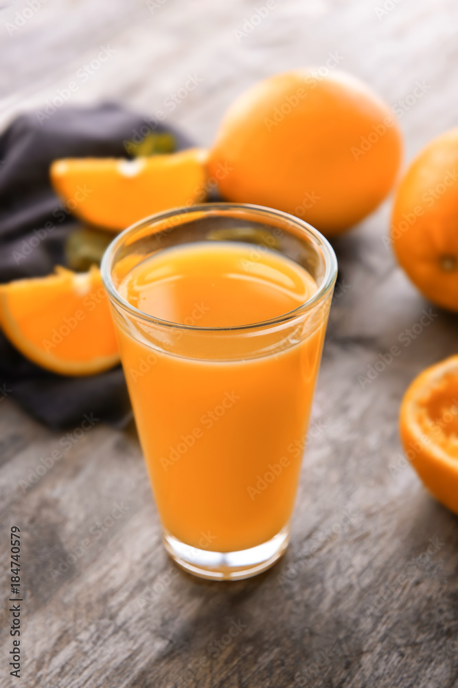 Glass of fresh orange juice on wooden background Glass of fresh orange juice on wooden background