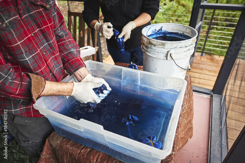 a man and woman tie dying clothing