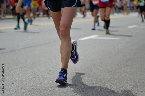 Marathon running race  many runners feet on road  sport  fitness and healthy lifestyle concept  