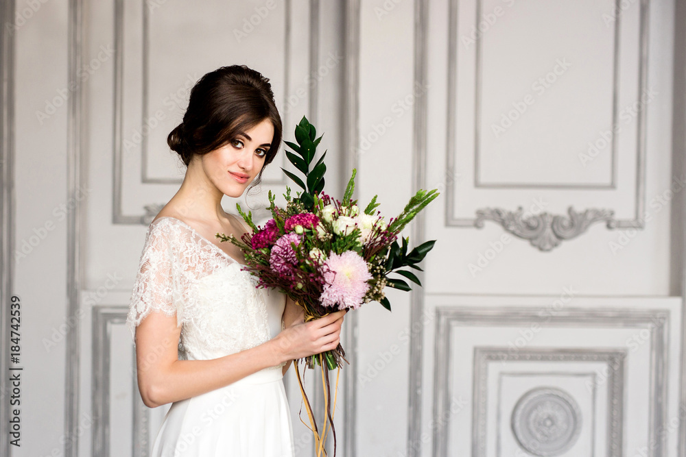 Wedding fashion bride with bouquet in hands