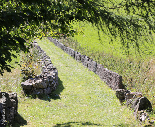 long mountain path bordered by stone slab photo