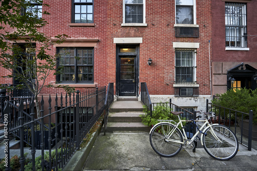 a bike and a brownstone building